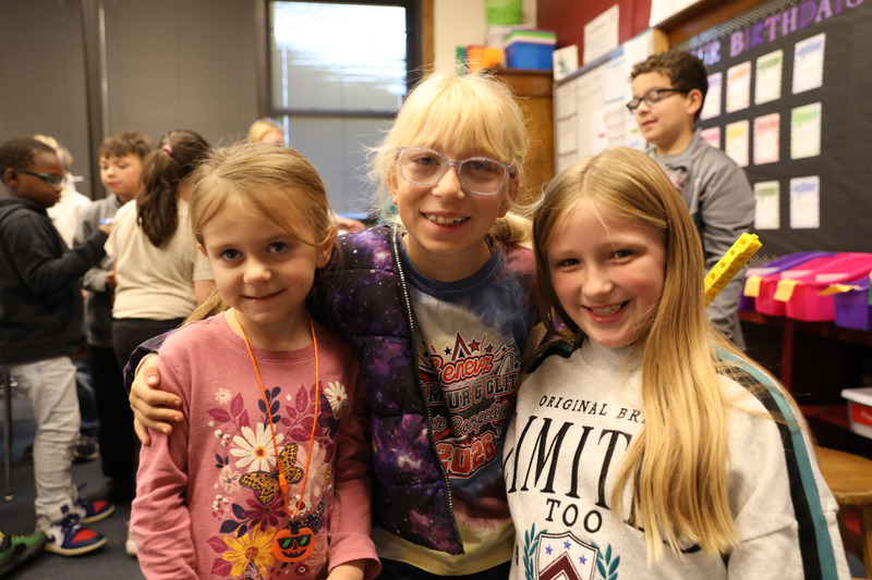 three students smiling