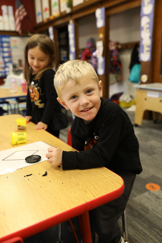 student playing with playdough