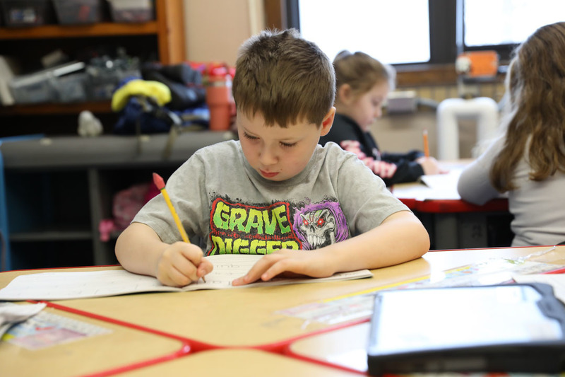 student practicing writing