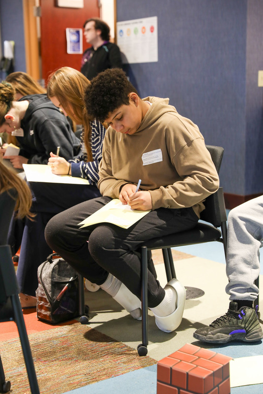 student writing at event