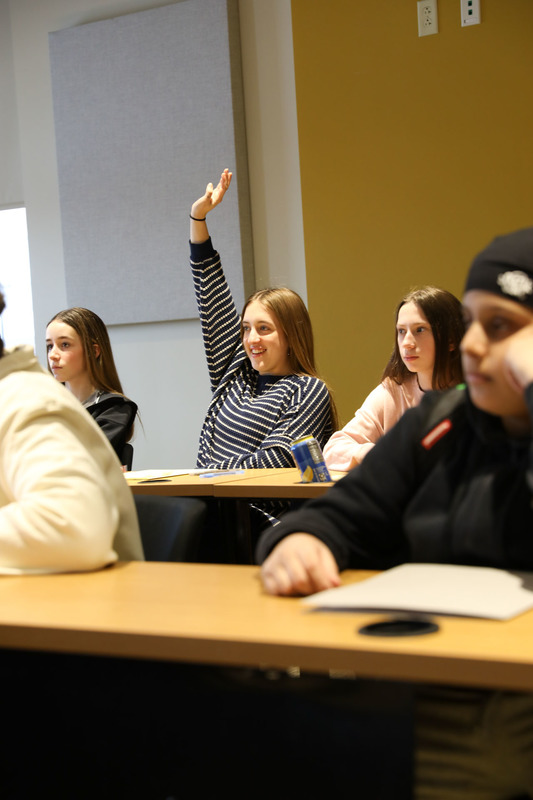student raising her hand
