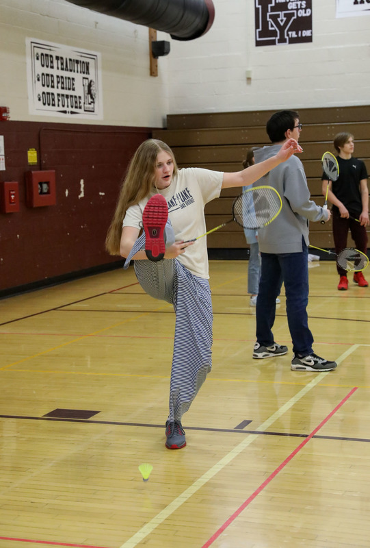student playing badminton in pe
