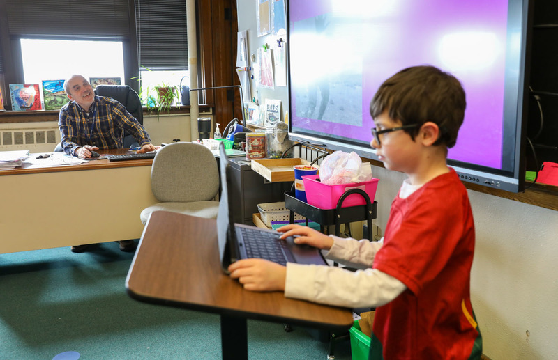 teacher watching student present