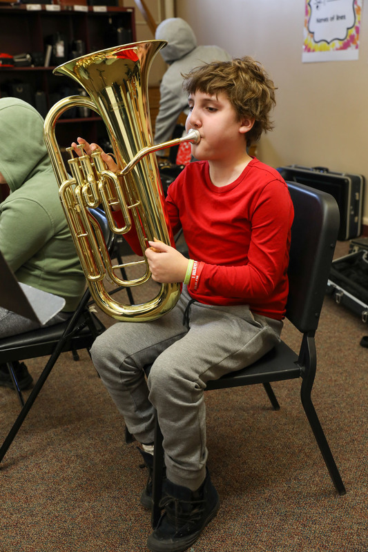 student with instrument in band