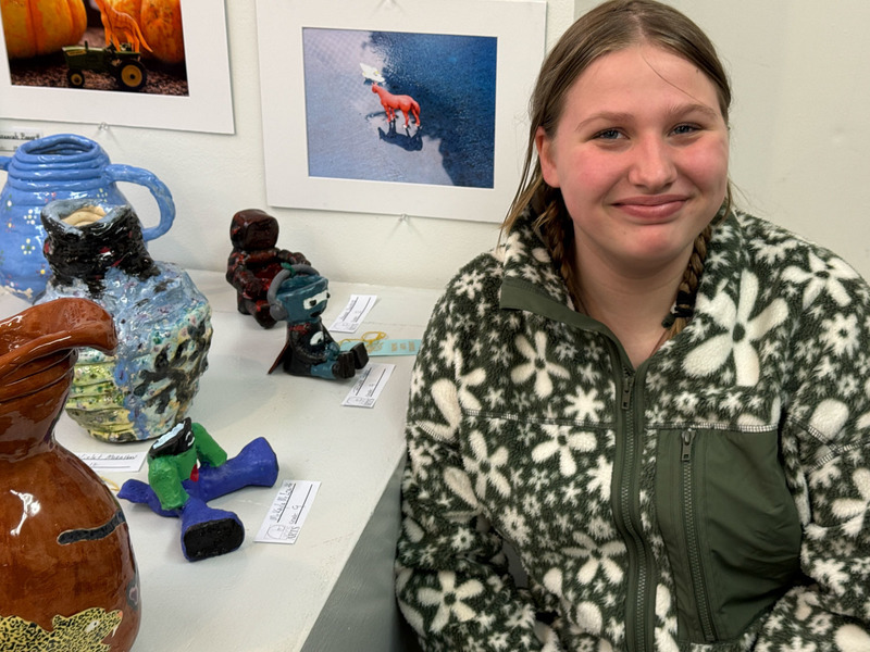 students posing with artwork