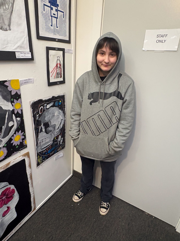 student with art work at the art show