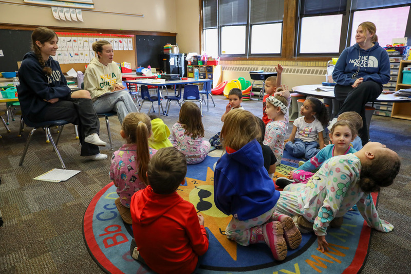 high schoolers reading to students