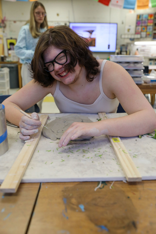 student working on art