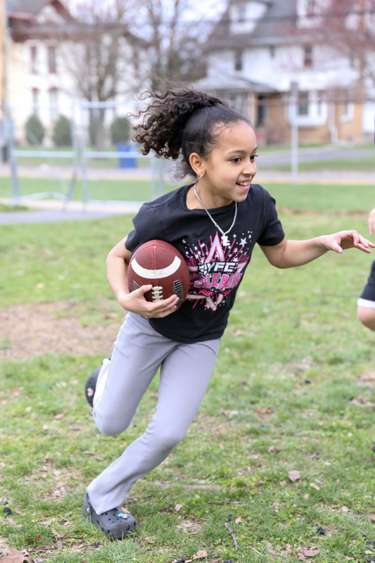 student playing football