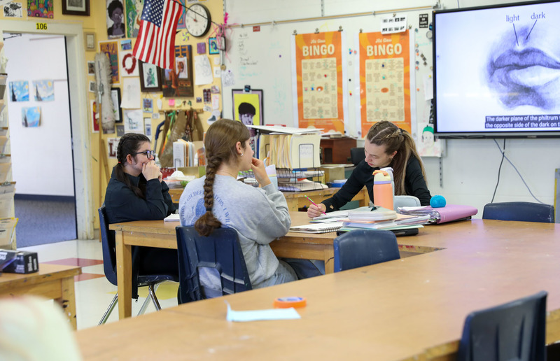 students at table in art class