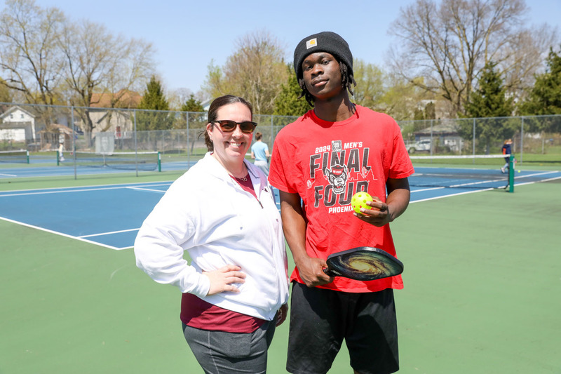 students playing pickleball outside