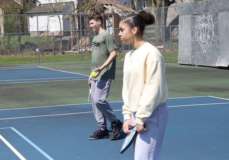 students playing pickleball outside