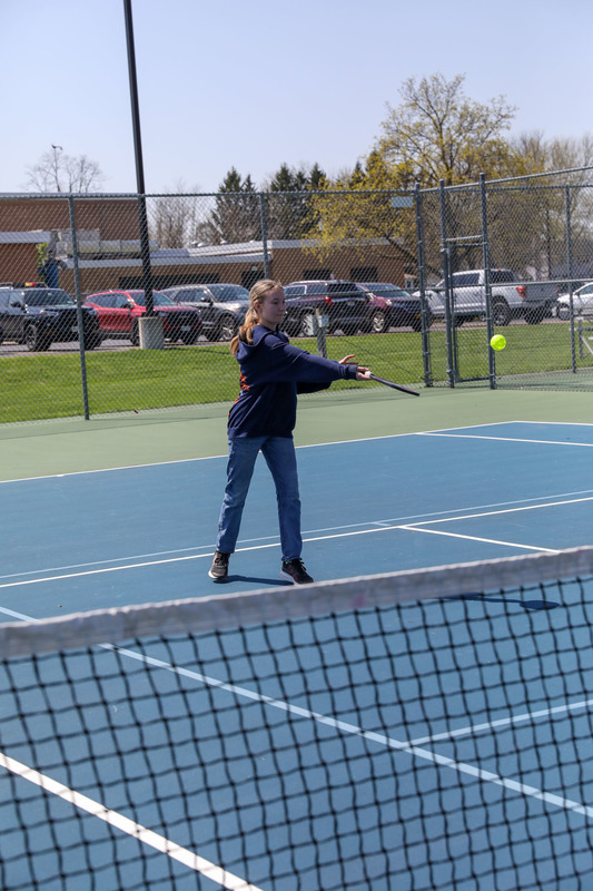 students playing pickleball outside