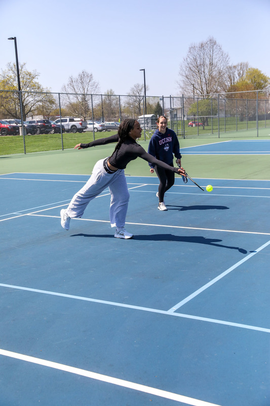 students playing pickleball outside