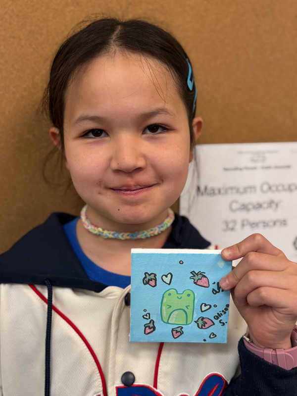 student posing with craft