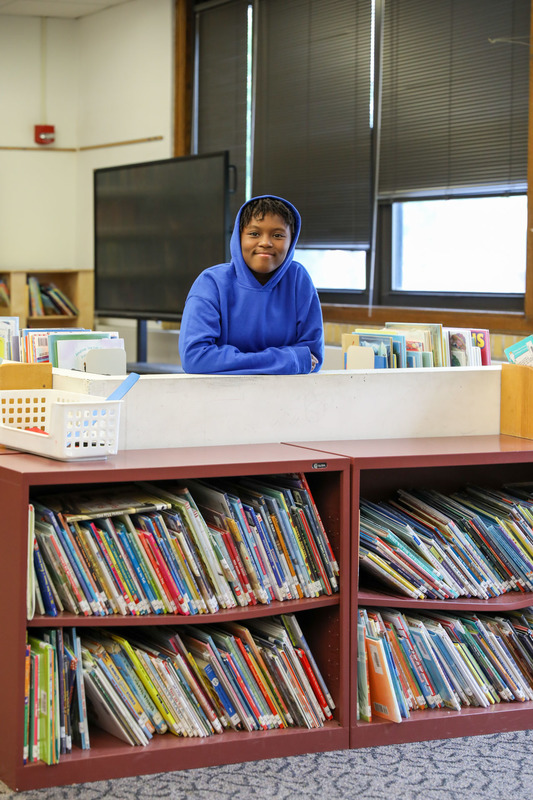 student in library
