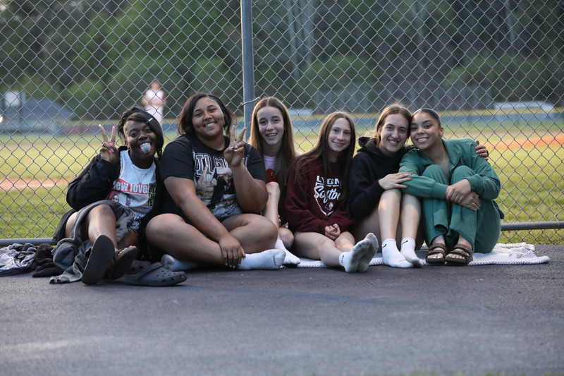 students posing at baseball game