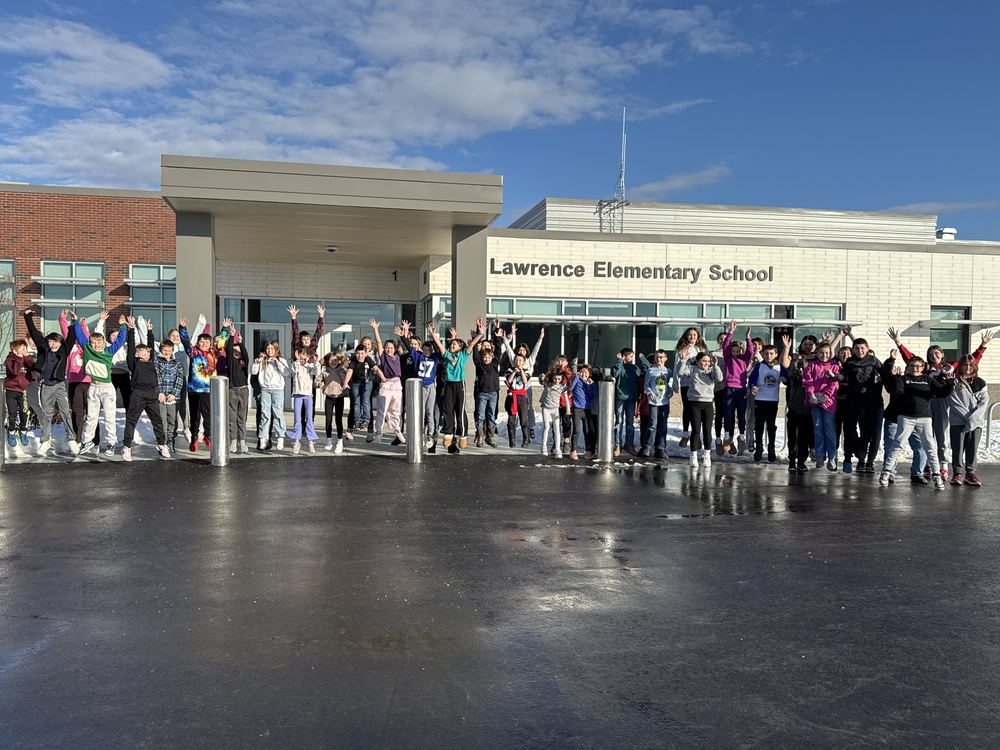 Picture of Lawrence Elementary School with many students and teachers standing and cheering