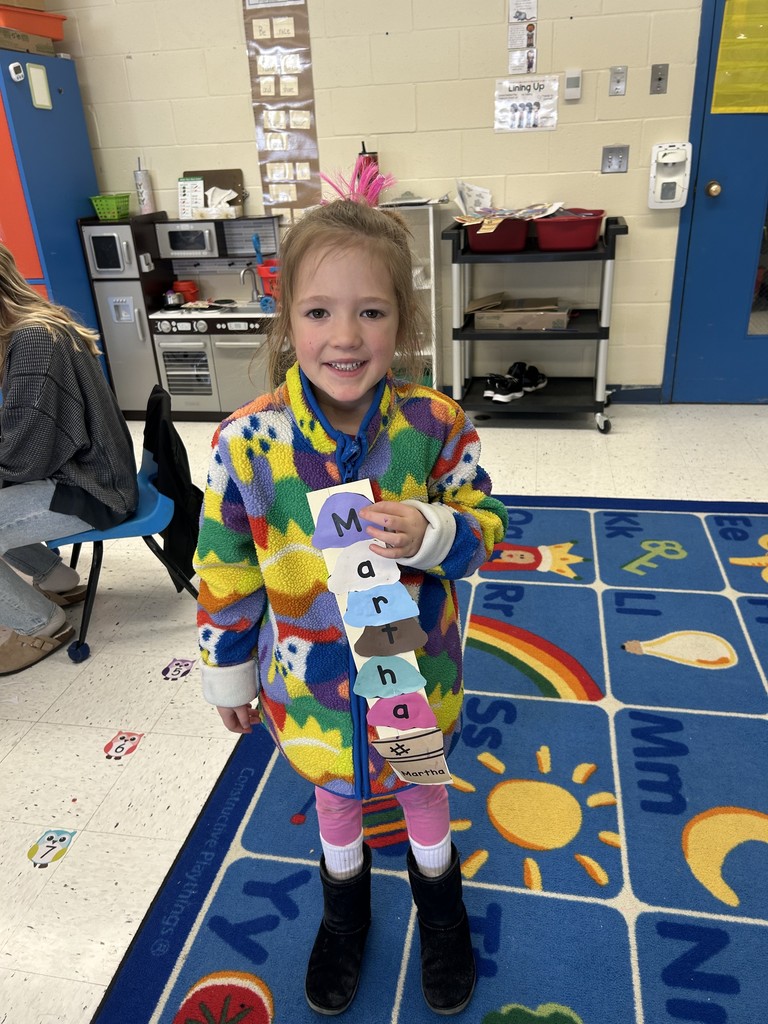 a student posing for a picture with their craft.