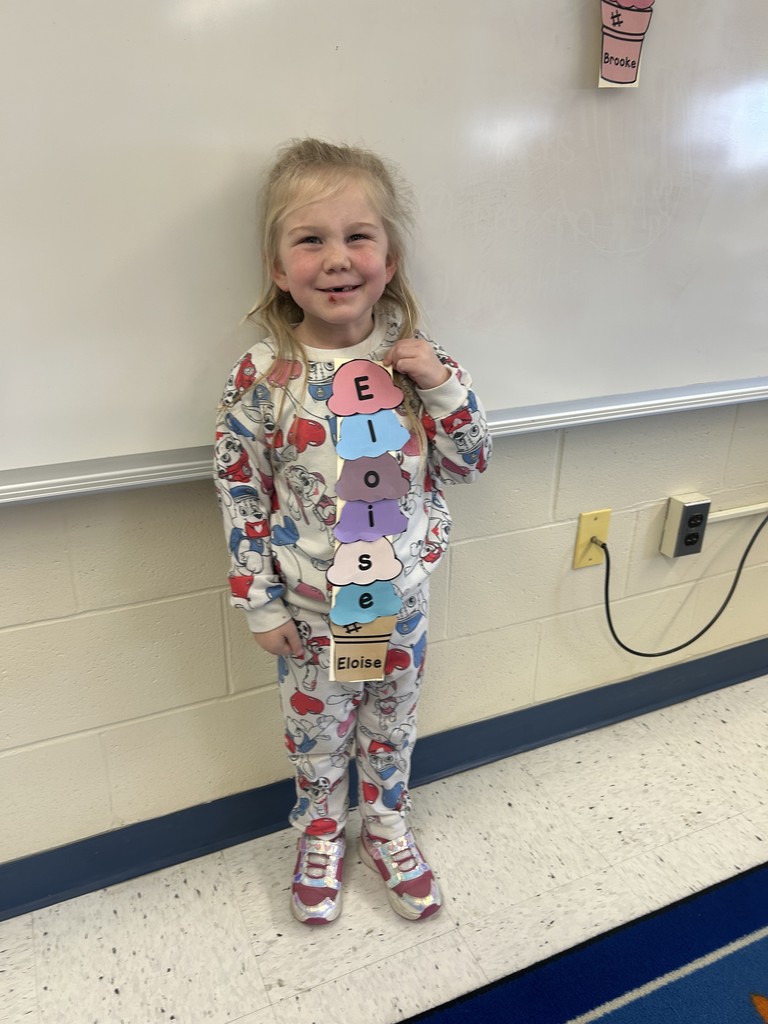a student posing for a picture with their craft.