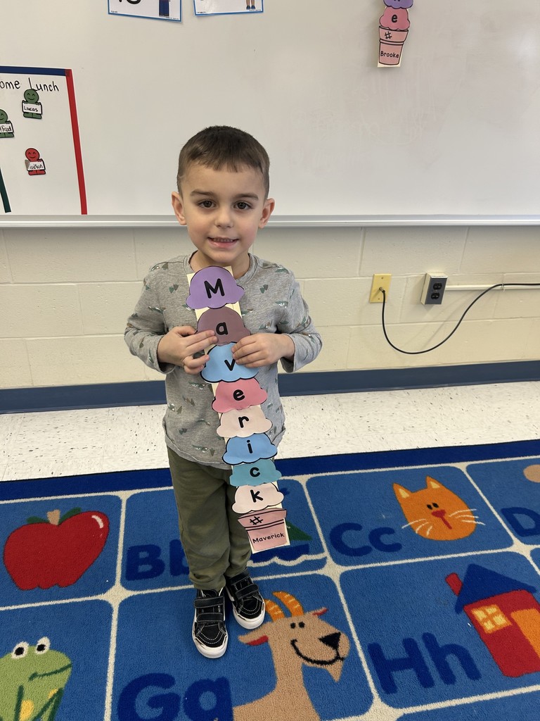 a student posing for a picture with their craft.
