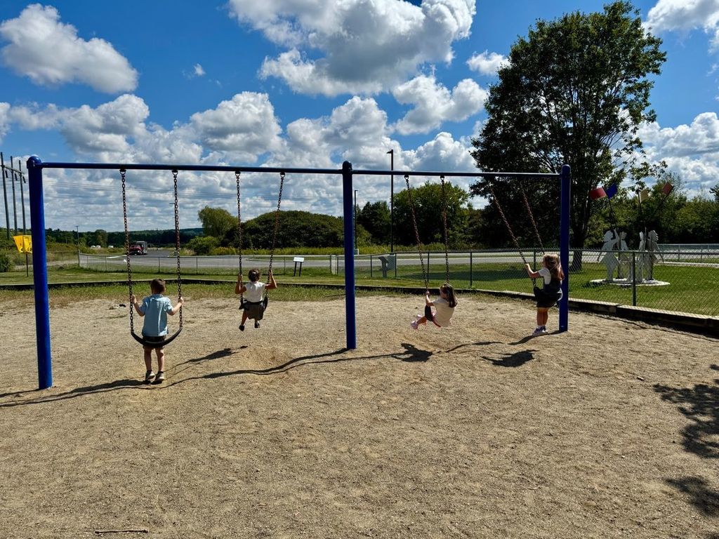 students swinging on swings.