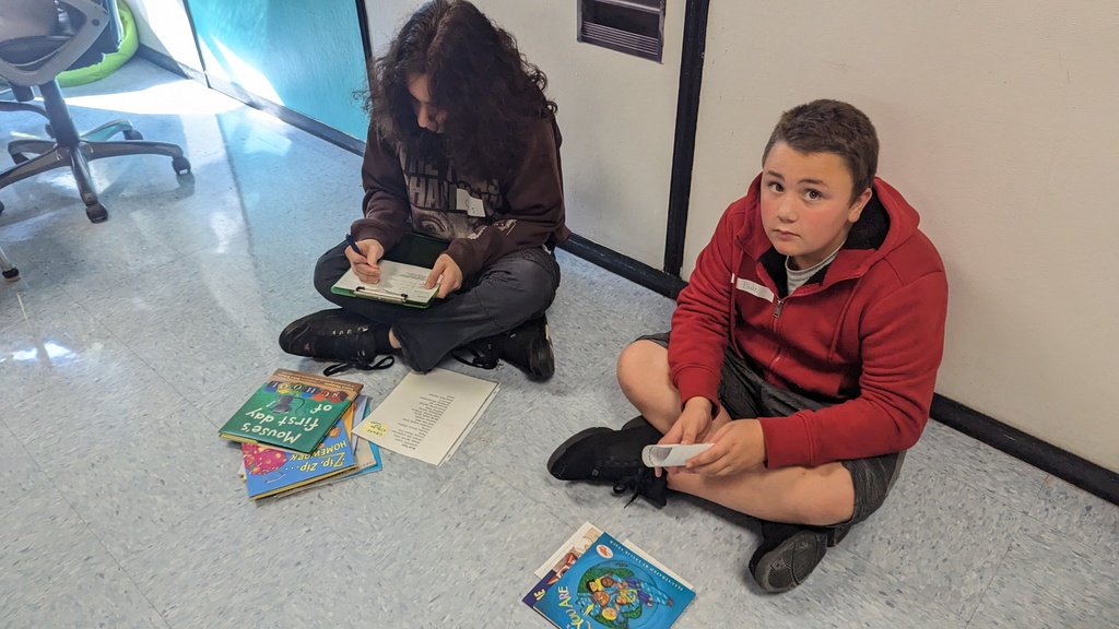 Students working on a book categorizing project.