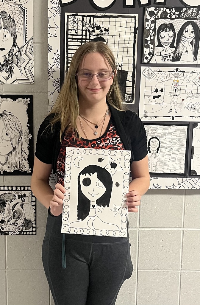 students showing off their spooky art.