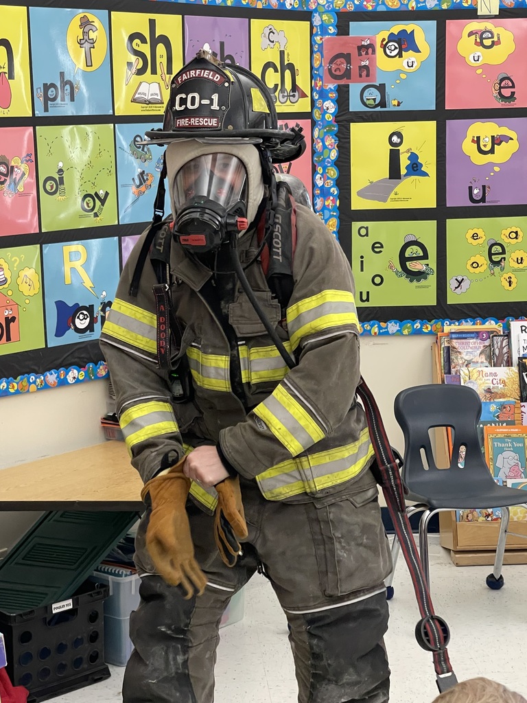 a fire fighter posing for a picture for fire safety class