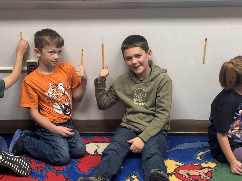 students posing for pictures during a science lesson