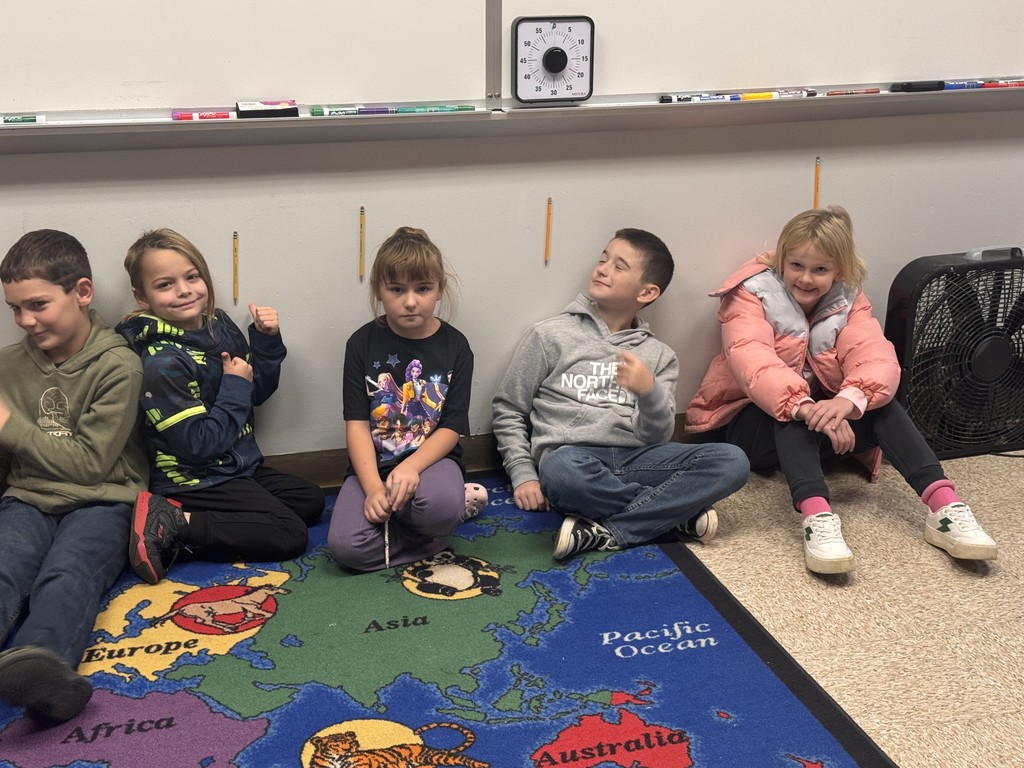 students posing for pictures during a science lesson