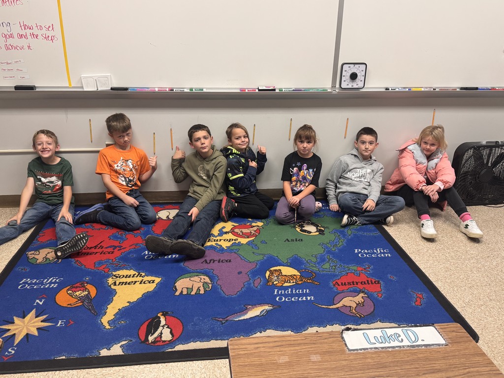 students posing for pictures during a science lesson