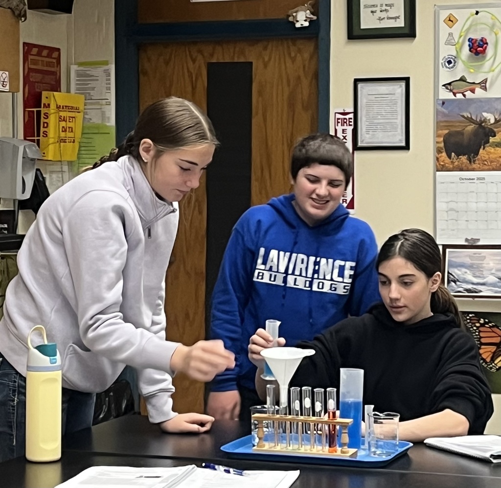 students working on a science experiment. 