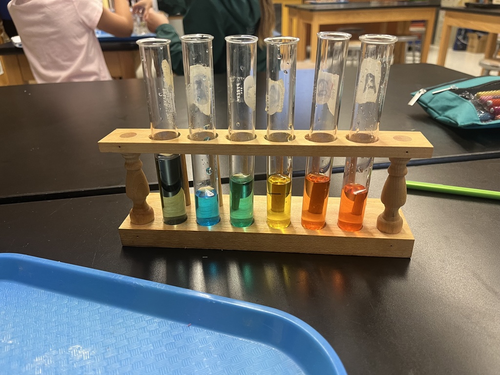 students working on a science experiment. 