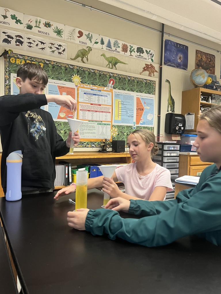 students working on a science experiment. 