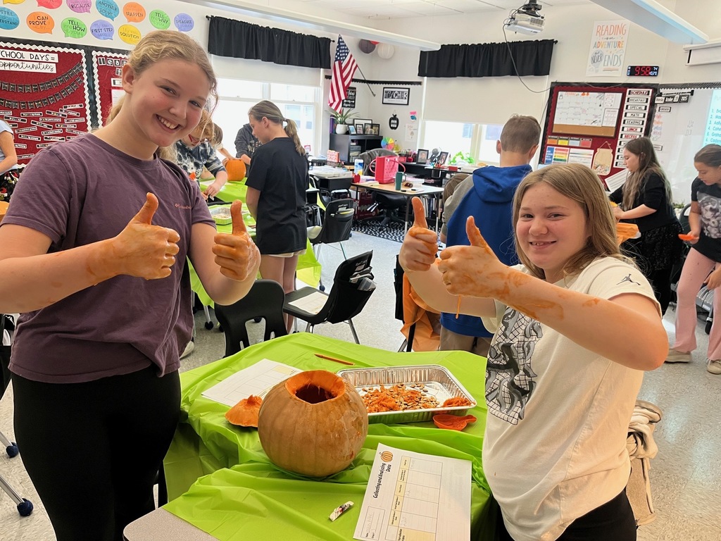 Students are involved in math activities using pumpkin seeds.