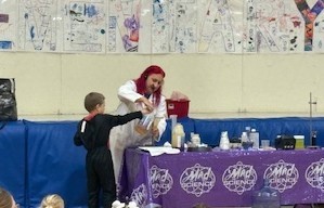 this picture is of a student helping with an experiment.
