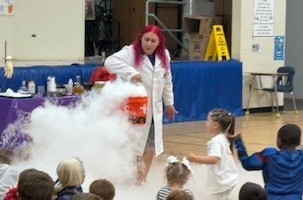 students in this picture are enjoying an experiment that created fog.