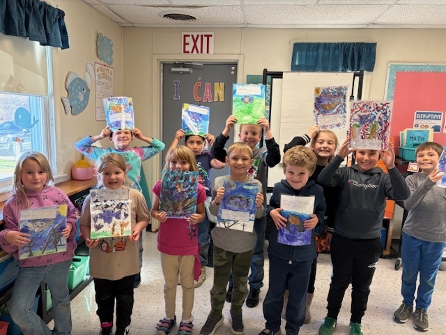 students showing their art.