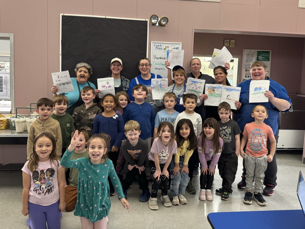 Students posing for a picture with the lunch ladies.
