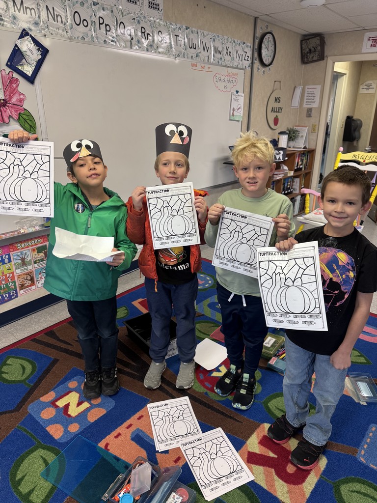 students posing with with their turkey crafts