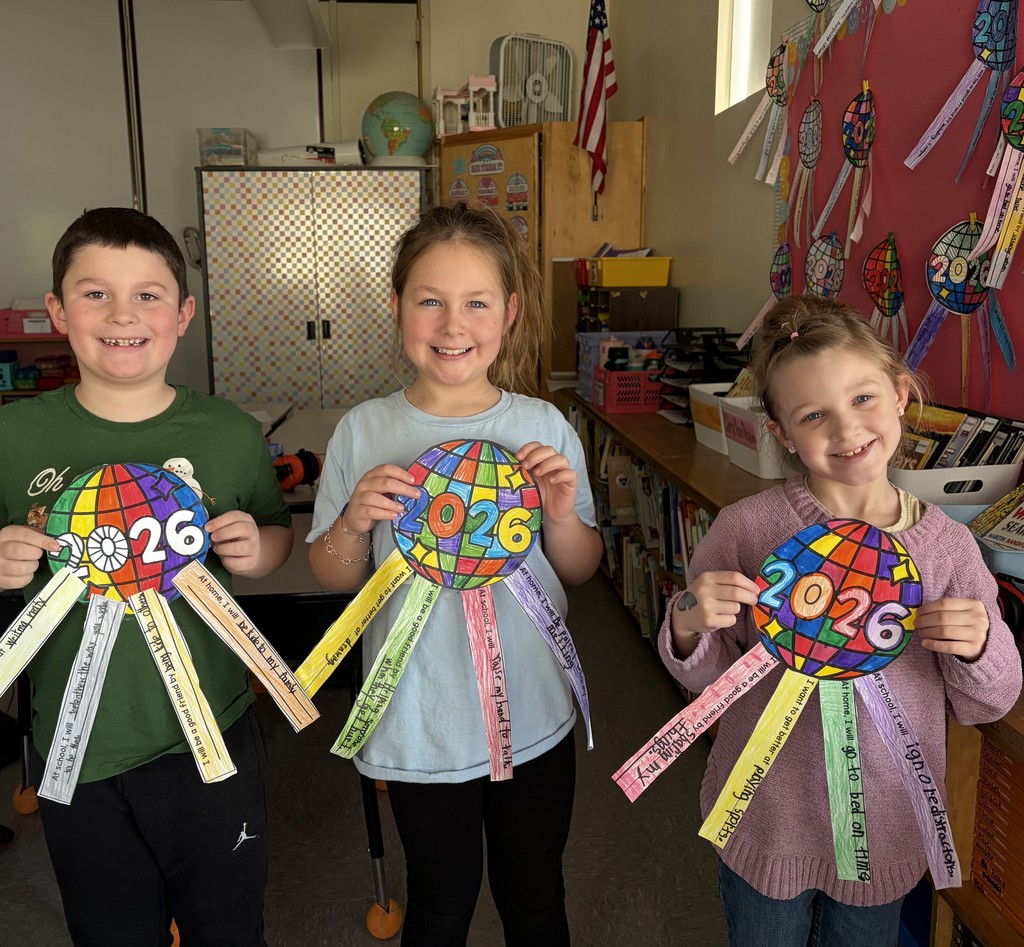 students showing off their artwork that also displays their new year goals.