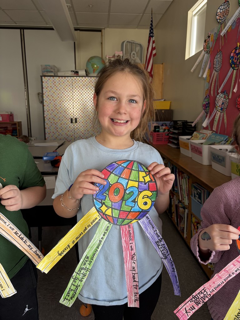 students showing off their artwork that also displays their new year goals.