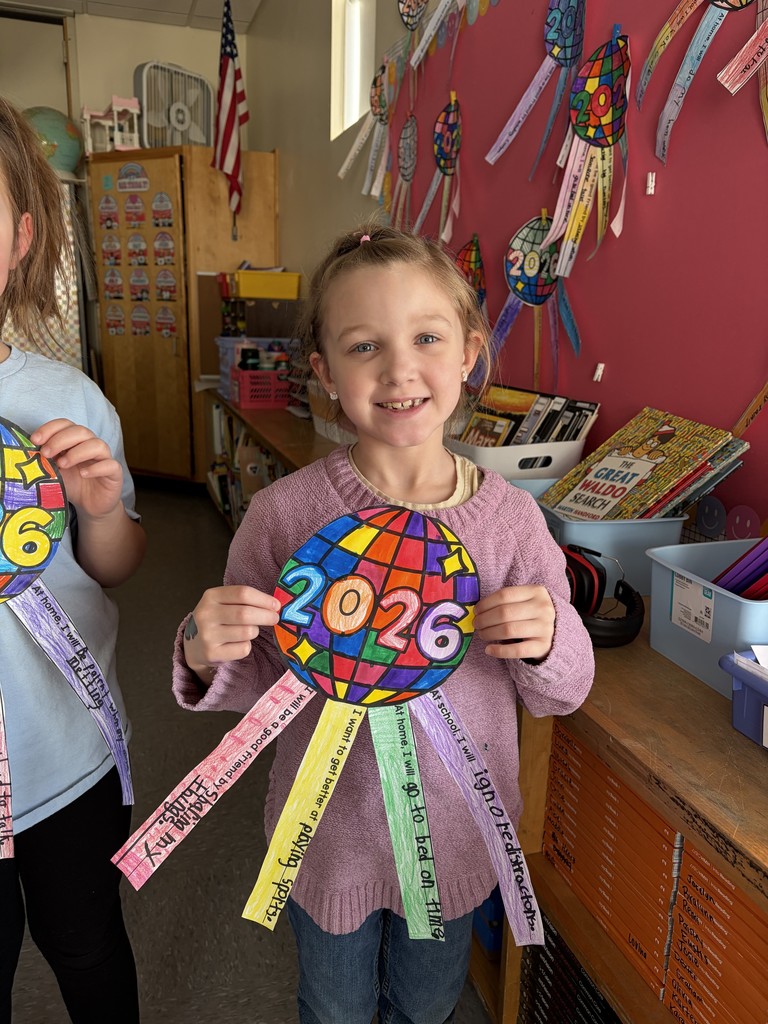 students showing off their artwork that also displays their new year goals.