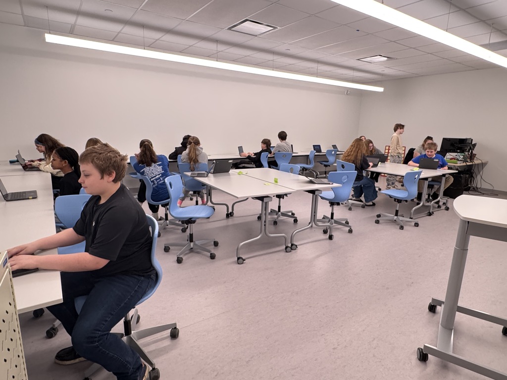 A picture of students in class at the new school. 