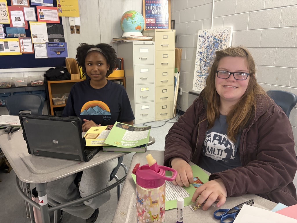 Students showing off their scrapbook pages of all they  have learned.