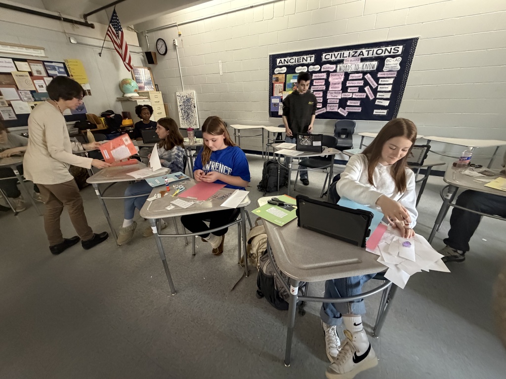 Students showing off their scrapbook pages of all they  have learned.