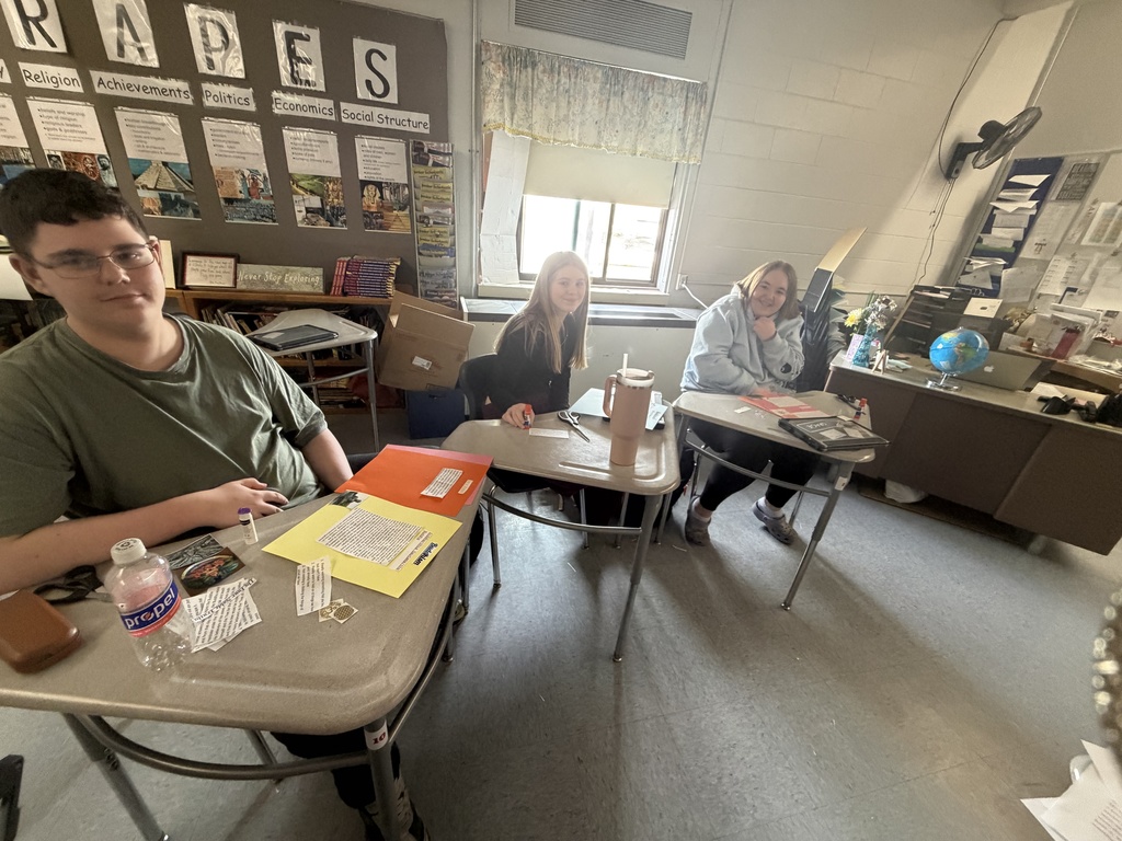 Students showing off their scrapbook pages of all they  have learned.