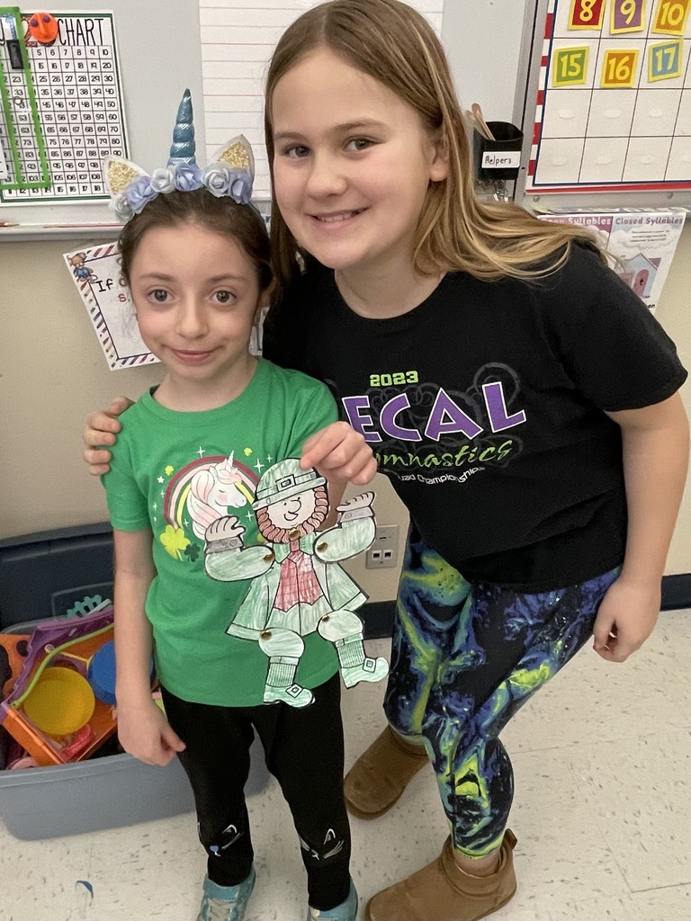 Pictures of students participating in buddy day and working on st patrick day crafts. 