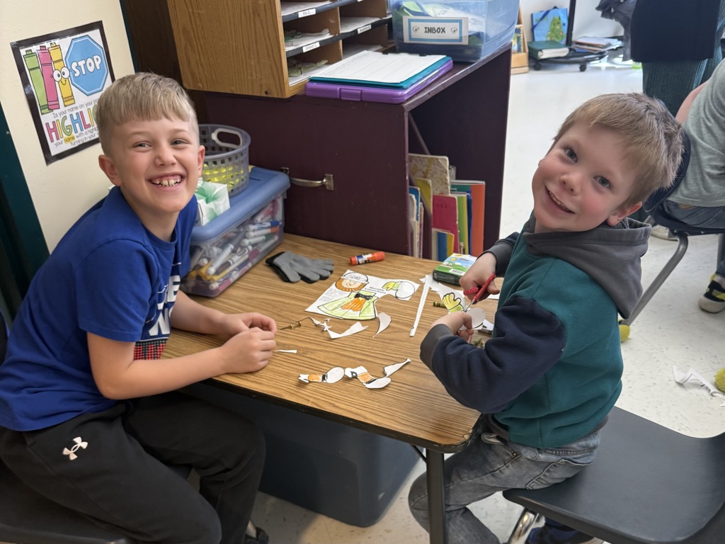 Pictures of students participating in buddy day and working on st patrick day crafts. 